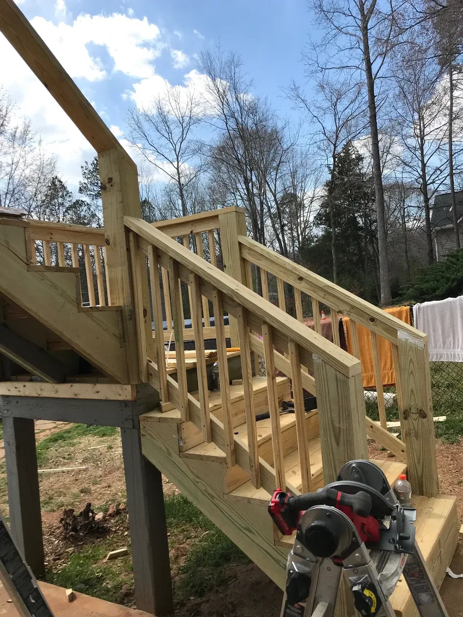 Close-up of wood deck handrails and steps framing
