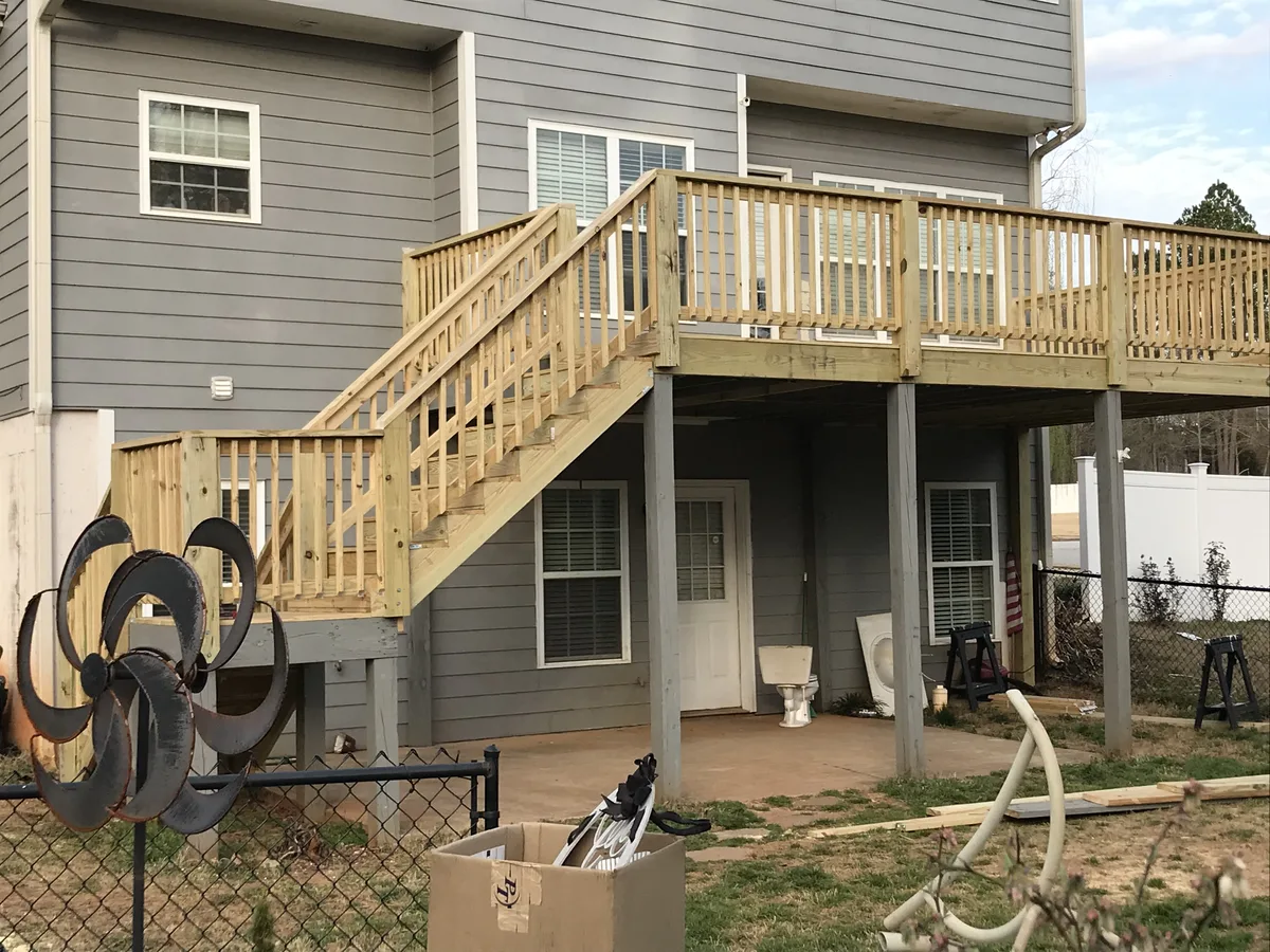 Completed deck showing stairs leading down to concrete patio