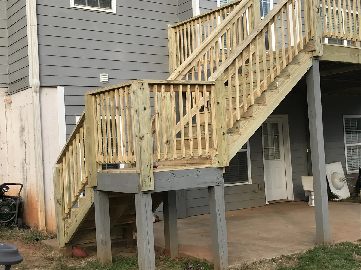 Close-up of wood deck landing, steps, and posts