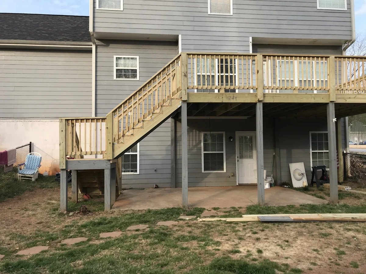 Completed custom deck wide angle view in backyard