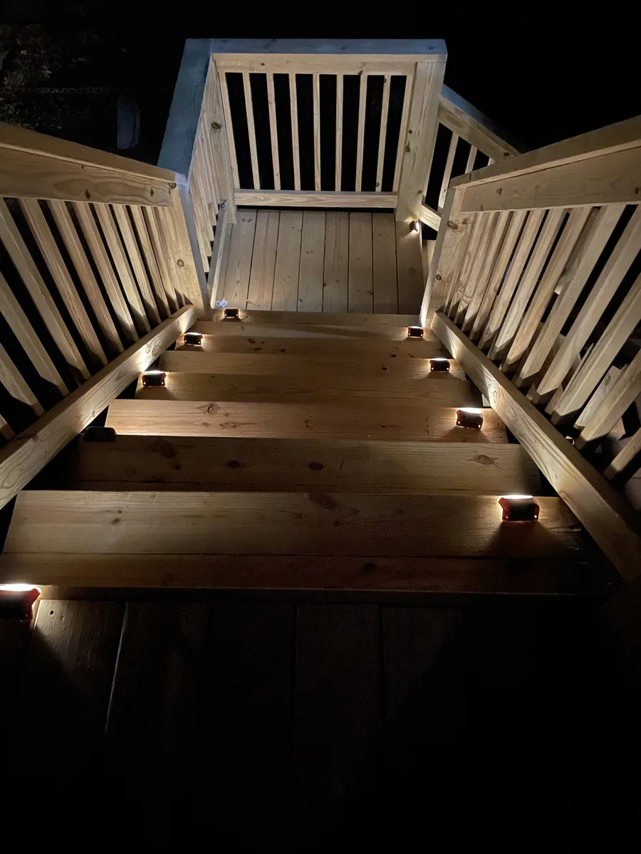 Warm LED riser lighting on deck stairs at night