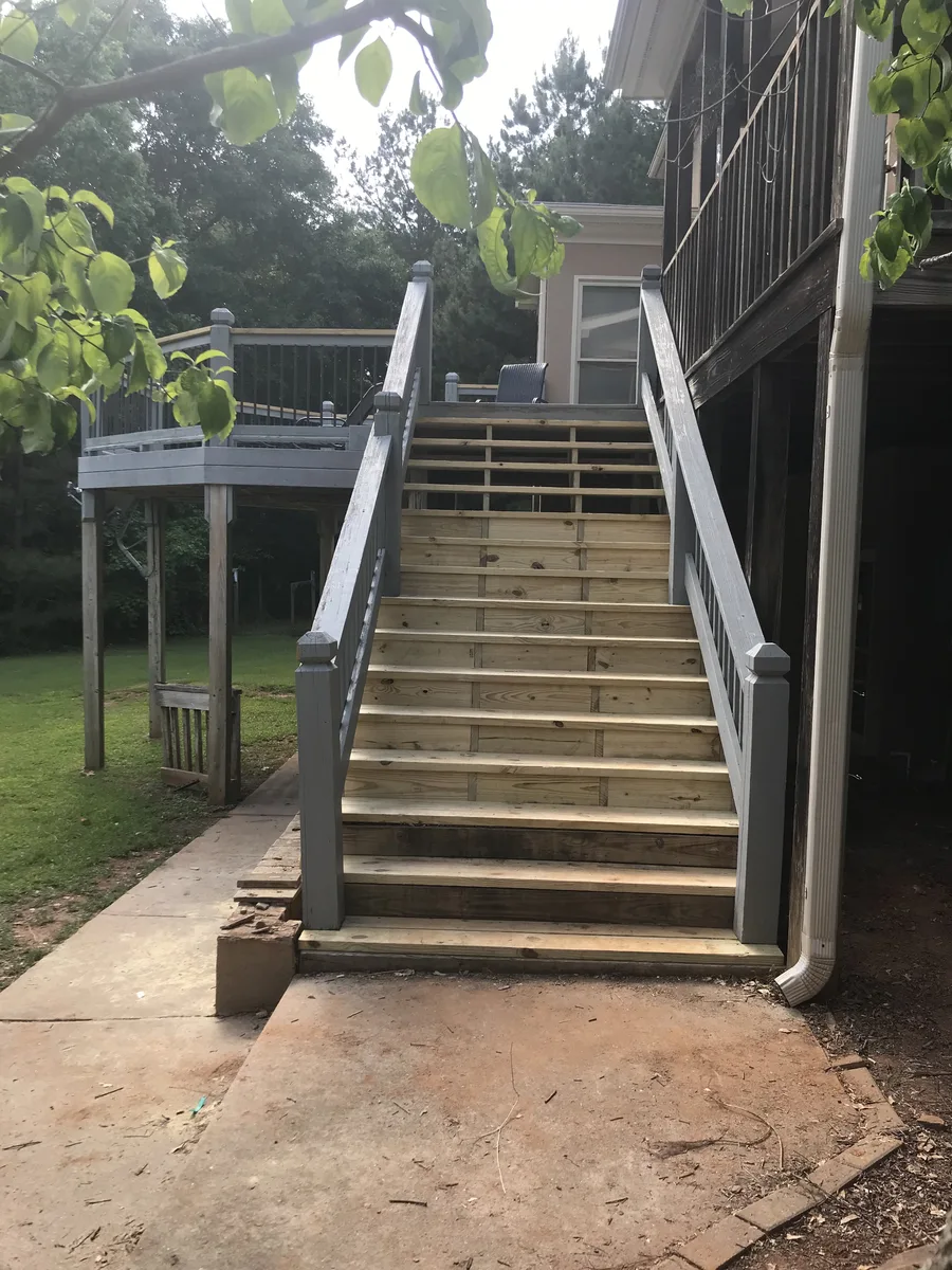 Deck stair construction showing stringer rebuild and step installation